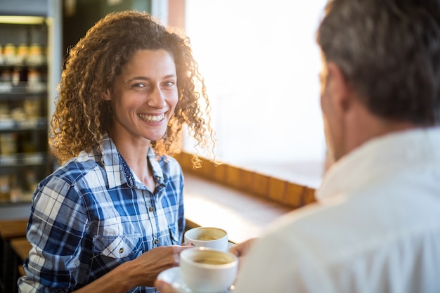 Smiling couple having coffee