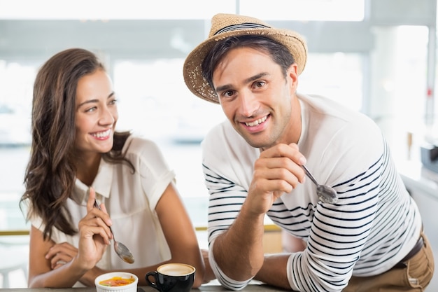 Smiling couple having dessert