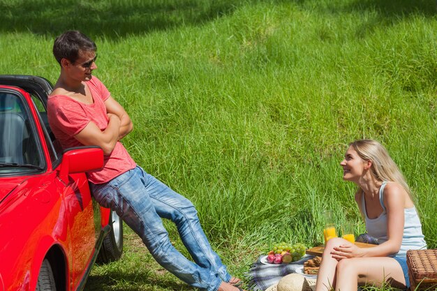 Smiling couple having picnic together