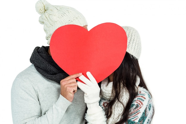 Smiling couple holding paper heart