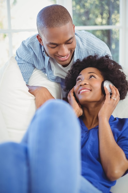 Smiling couple in living room at home