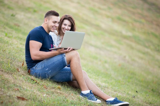 Smiling couple looking at a laptop