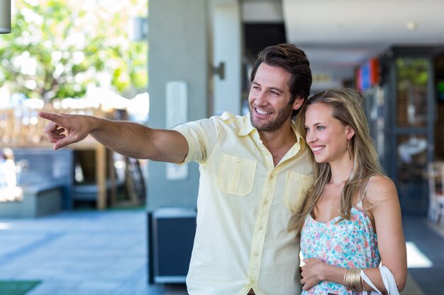 Smiling couple looking and pointing