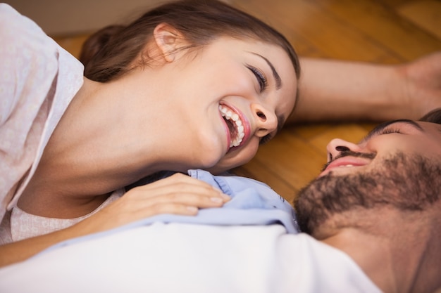 Smiling couple lying on the floor