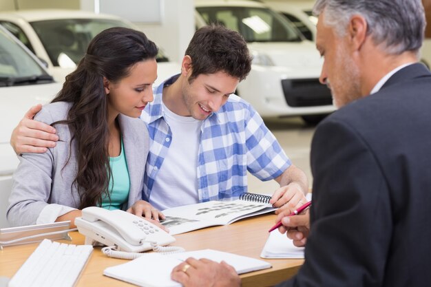 Smiling couple reading a booklet