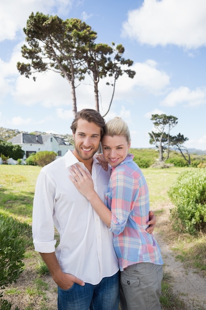 Smiling couple standing outside together in their garden