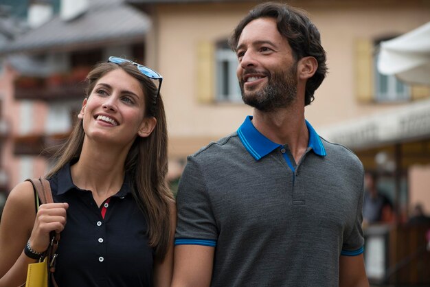 Smiling couple strolling in a town