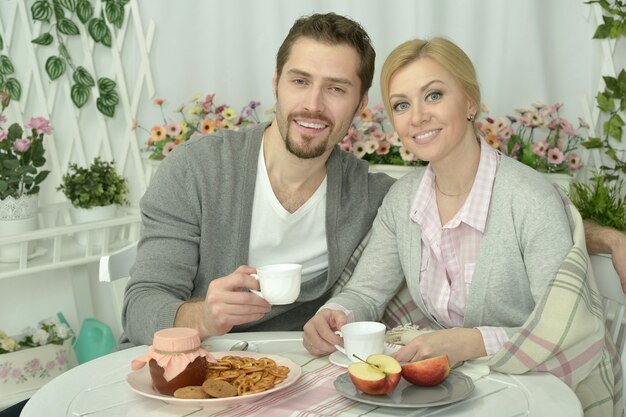 Smiling couple at table with coffee and food