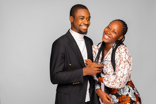 Smiling couple using phone at home