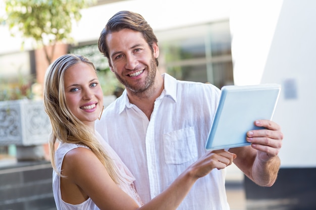 Smiling couple using tablet computer