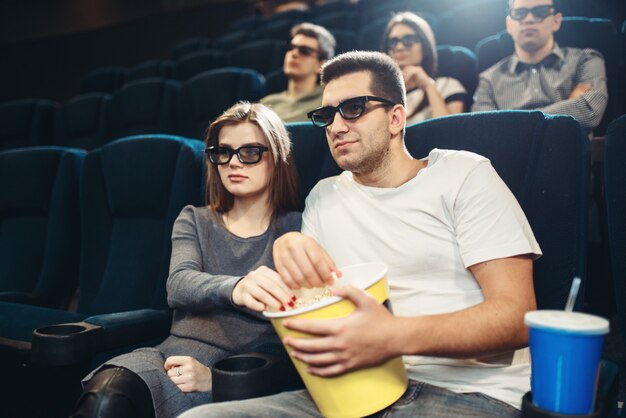 Smiling couple watching comedy movie in cinema