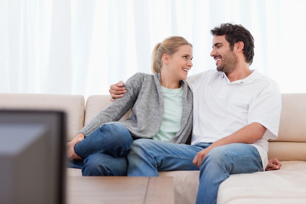 Smiling couple watching TV