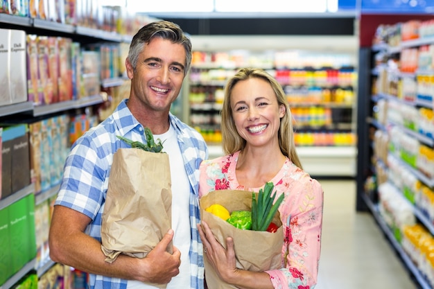 Smiling couple with grocery bags