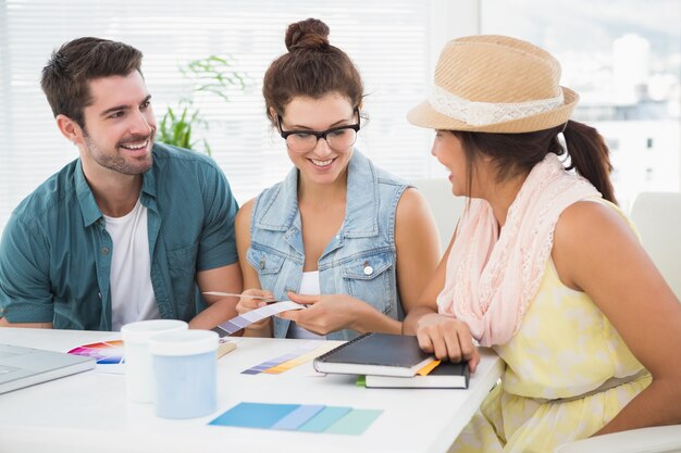 Smiling coworkers using colour wheel 