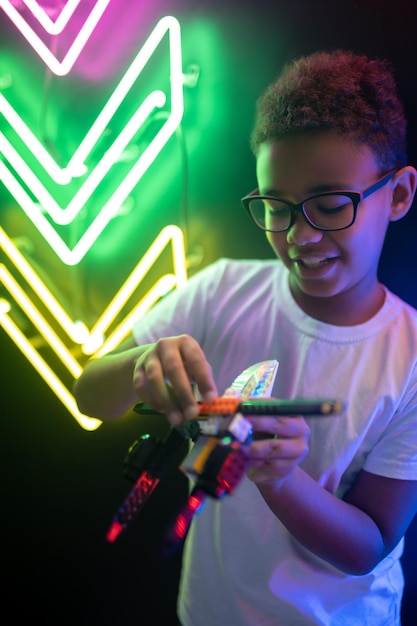 Smiling cute adolescent with a toy chopper