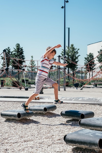 Smiling cute boy jumping on a playground