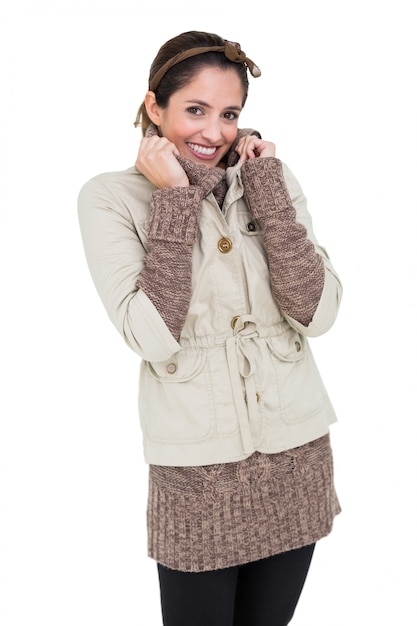 Smiling cute brunette in winter fashion holding collar