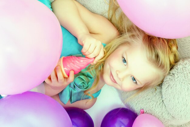 Smiling cute young girl posing at camera closeup