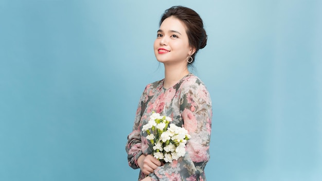 Smiling cute young woman florist with flower bouquet