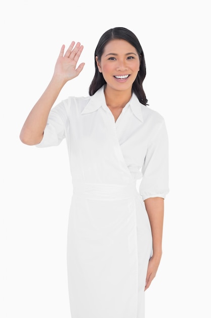 Smiling dark haired model with classy dress greeting