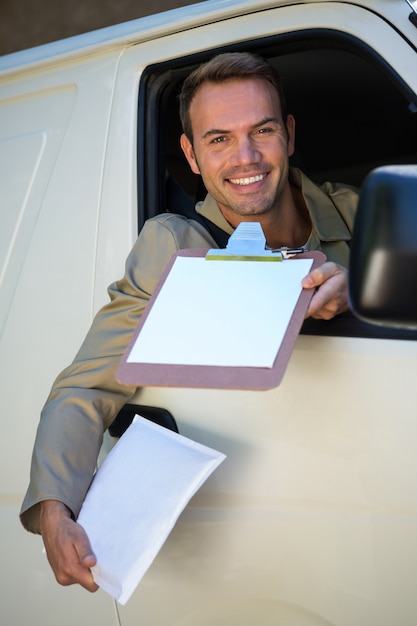 Smiling delivery man sitting in his van