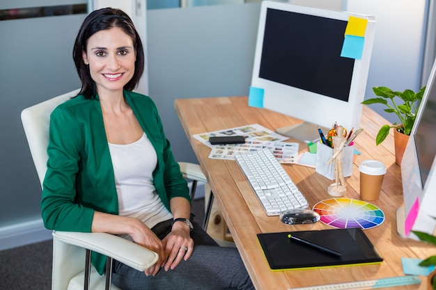 Smiling designer sitting at her desk