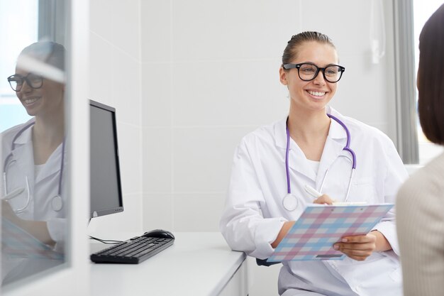 Smiling Doctor Consulting Patient