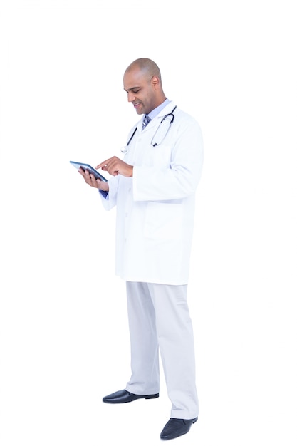 Smiling doctor using tablet