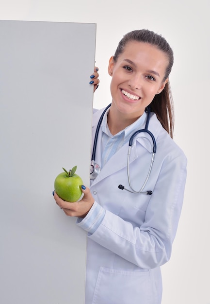 Smiling doctor with apple and blank banner Woman doctors