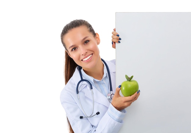 Smiling doctor with apple and blank banner