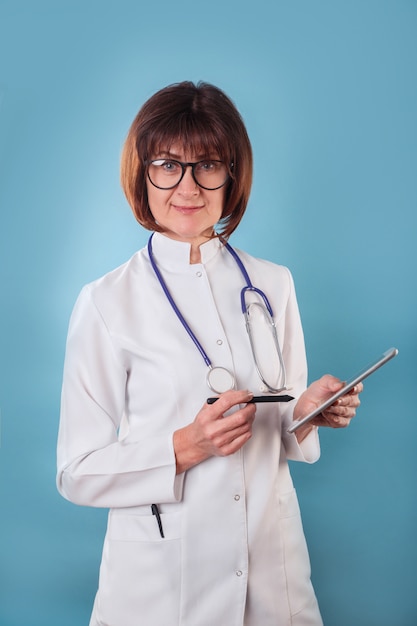 Smiling doctor with clipboard on blue background