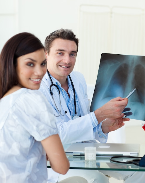 Smiling doctors examining an xray