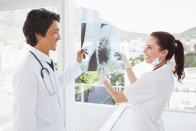 Smiling doctors holding an x ray