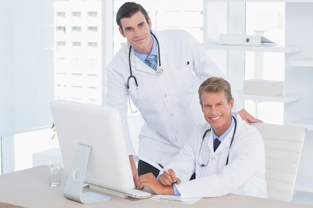 Smiling doctors looking at camera 