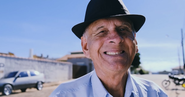 Smiling elderly man looking at camera