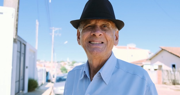 Smiling elderly man looking at camera