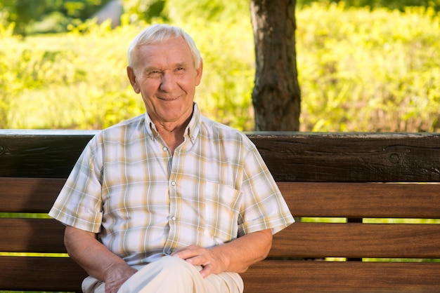 Smiling elderly man senior male on bench memories of good old times i achieved everything i wanted