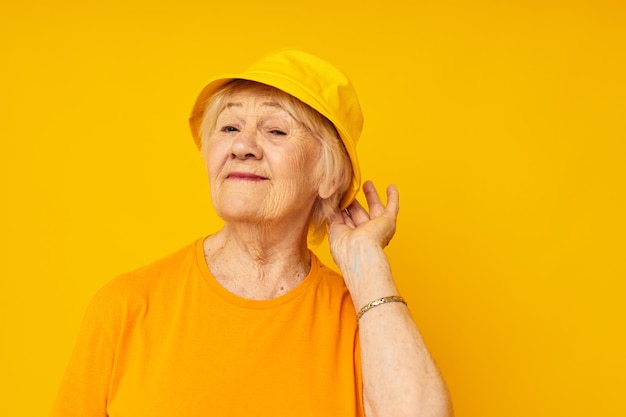 Smiling elderly woman happy lifestyle in a yellow headdress closeup emotions