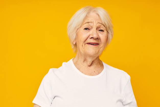 Smiling elderly woman in white tshirt posing fun closeup emotions