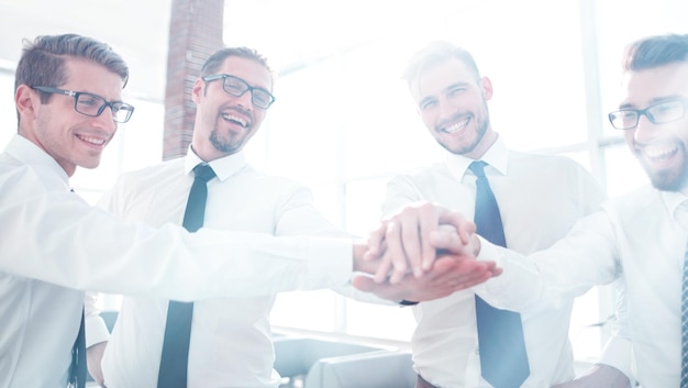 Smiling employees of the company folded the tower from his hands