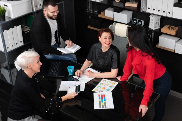 Smiling employees talking in workplace