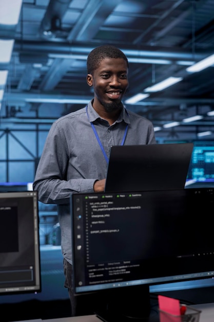 Smiling engineer pleased by recovery plan monitoring data center