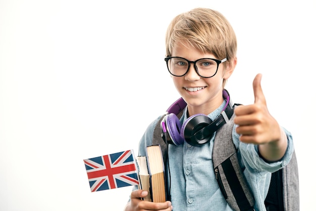 Smiling english schoolboy shows thumbs up