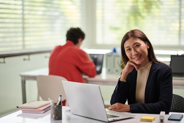 Smiling Entrepreneur at Office Desk