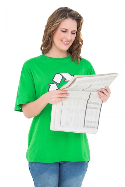 Smiling environmental activist reading newspaper