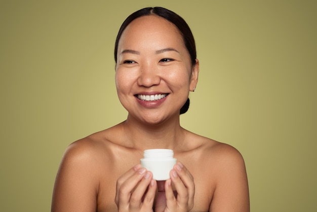 Smiling ethnic woman with cream