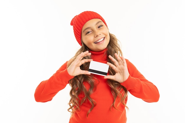Smiling european cute girl holding a credit card in her hands