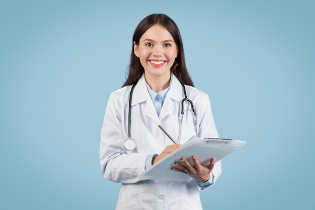 Smiling european female doctor holding clipboard