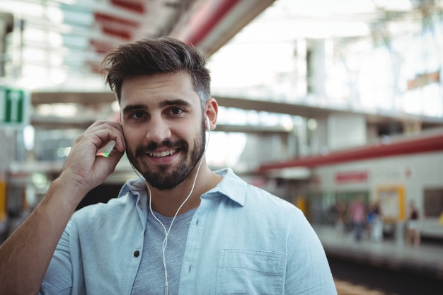 Smiling executive listening to music on headphones