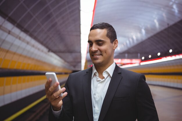 Smiling executive using mobile phone